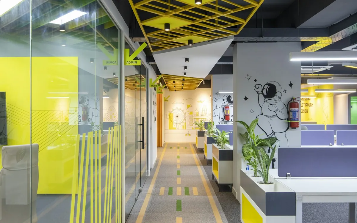 Office corridor with yellow floor markings and glass partitions