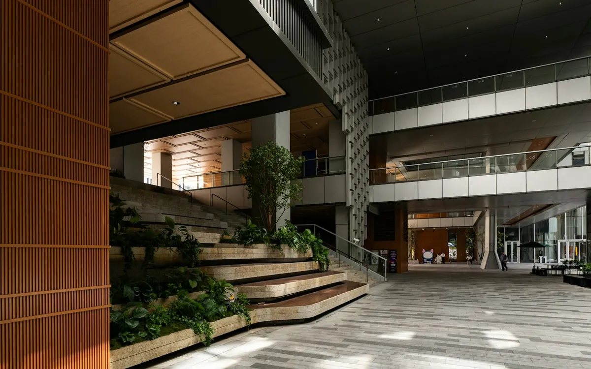 Dark timber and glass atrium with stepped garden terraces