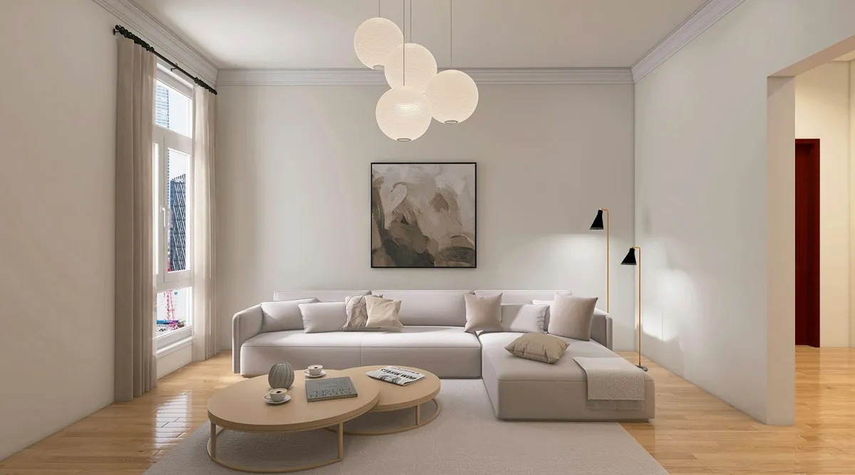 Soft-lit modern living room with a large sofa and framed art