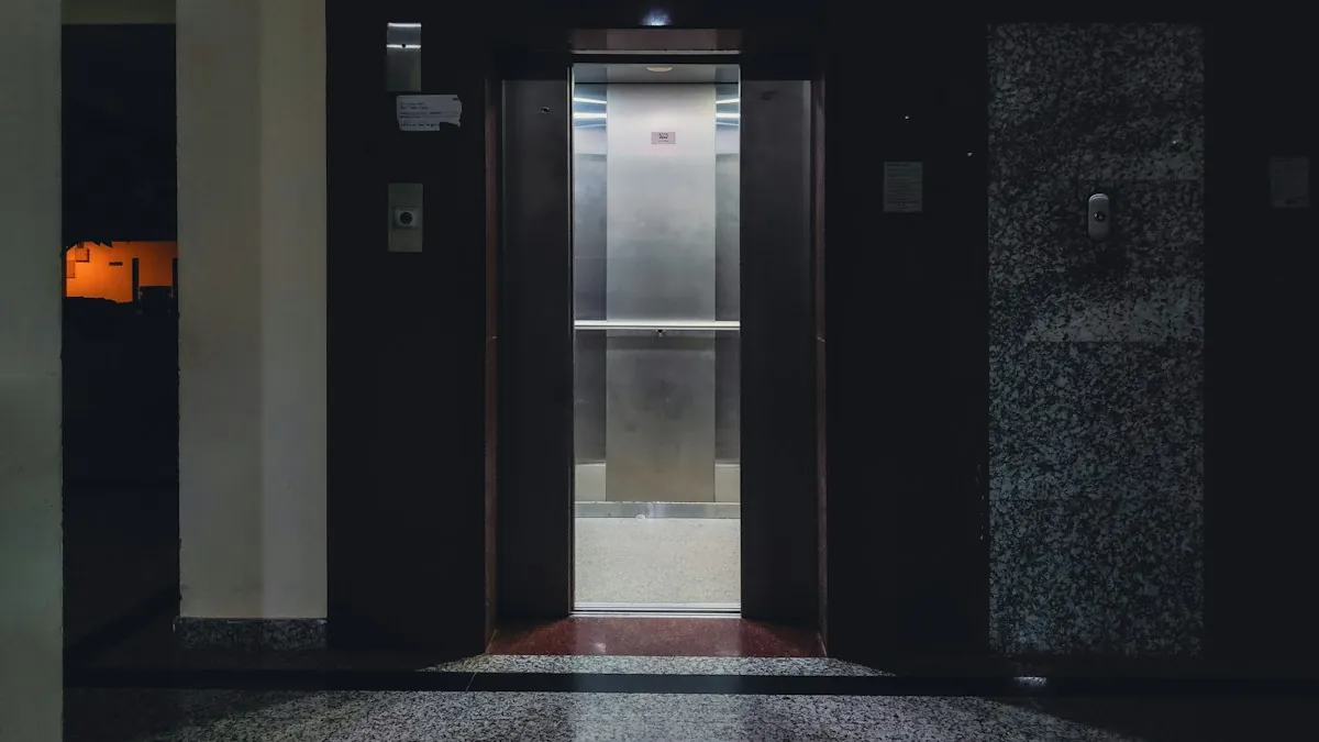 Open lift doors at the end of a dark corridor