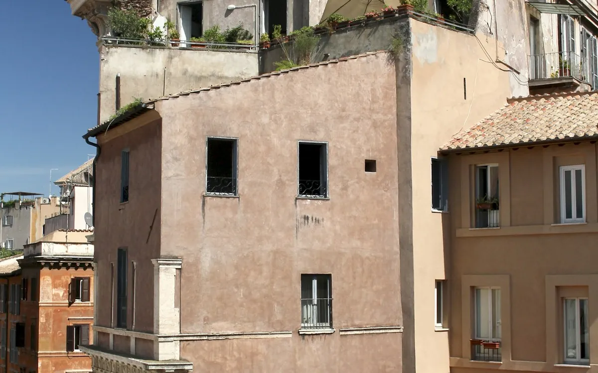 Old multi-storey stone building with weathered balconies