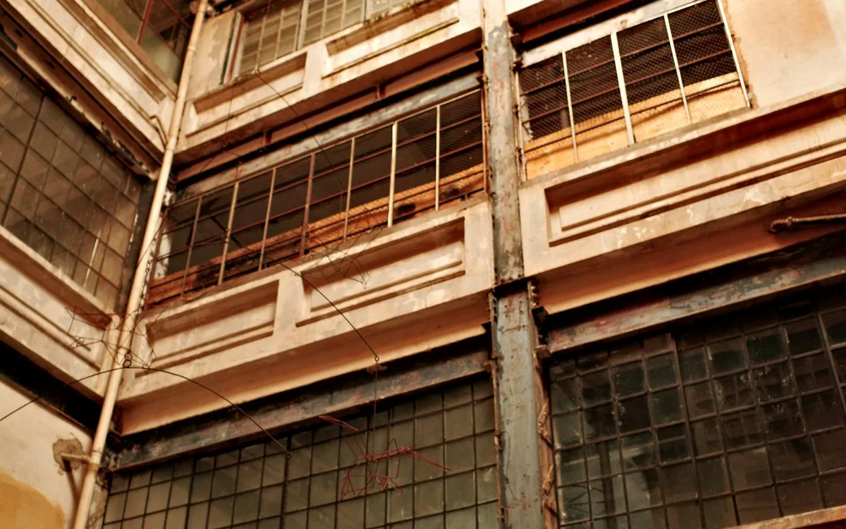 Weathered multi-storey atrium with warm light and balconies