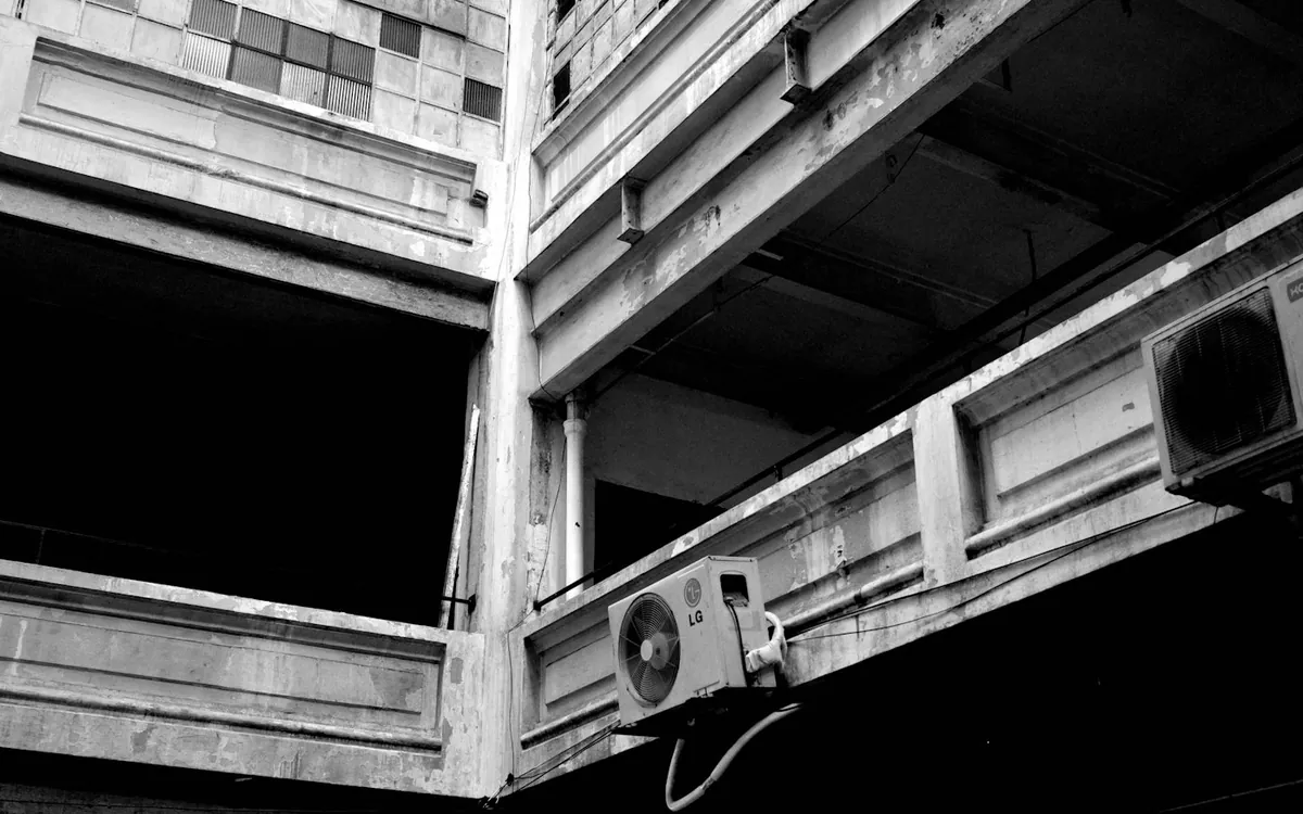 Black and white view up inside a tall old industrial building