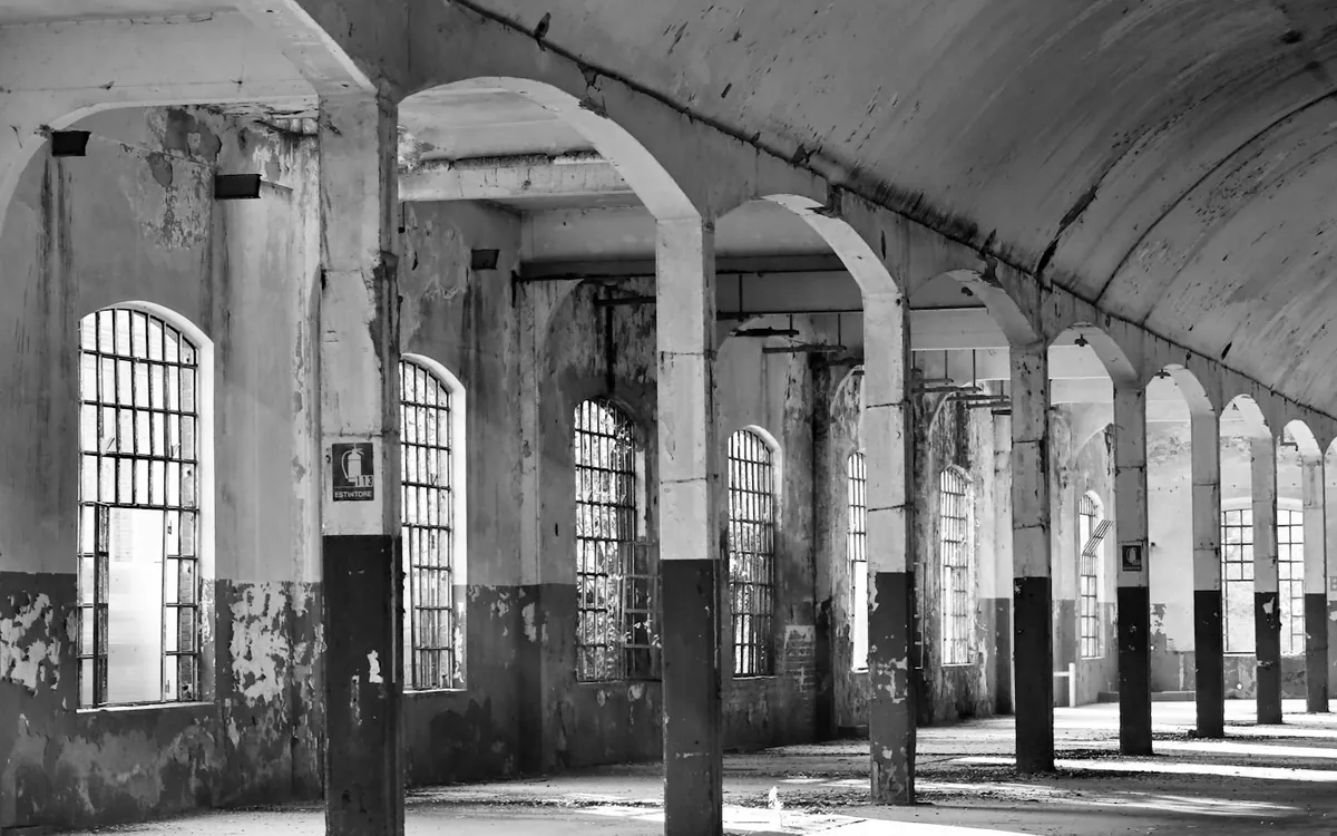 Black and white arched hall with columns and shafts of light