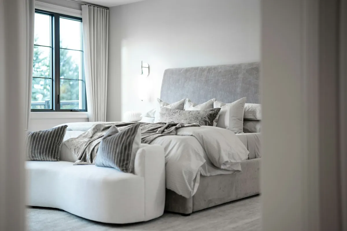 Calm bedroom with a curved sofa-style bed and soft grey tones