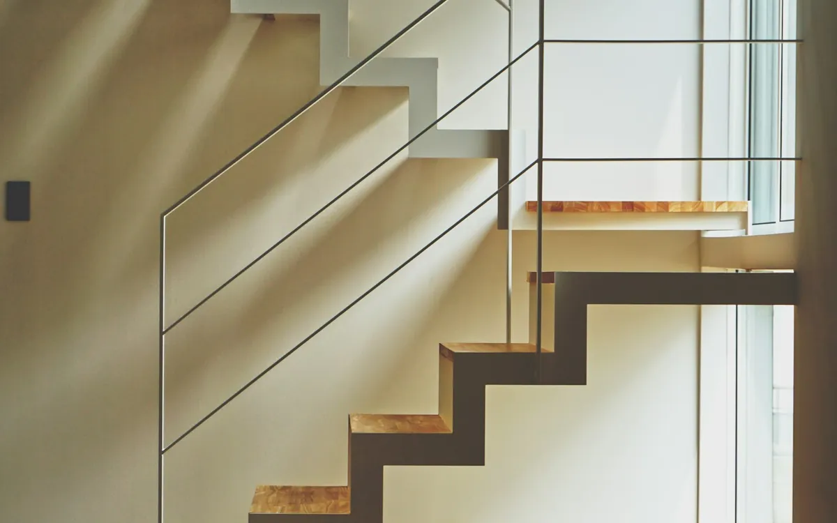 Wooden staircase with white railings inside a home