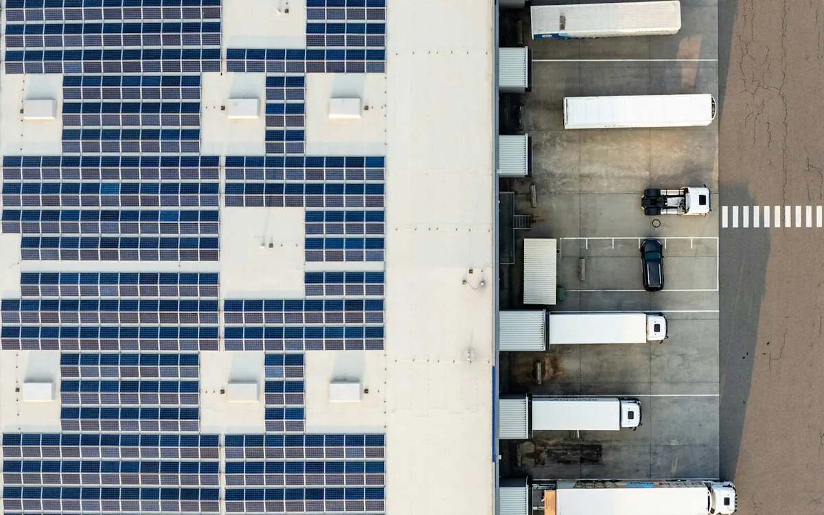 Aerial view of a building roof covered with solar panels