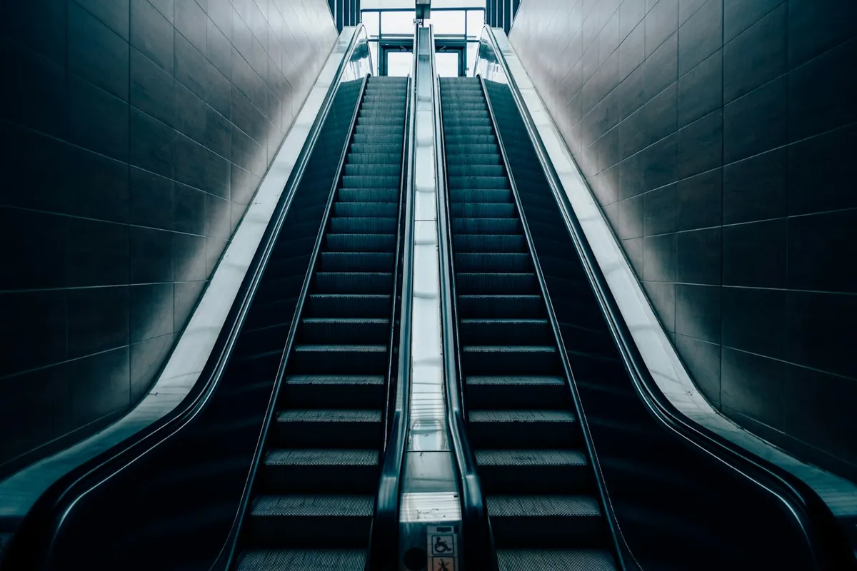 Escalator inside a modern white building