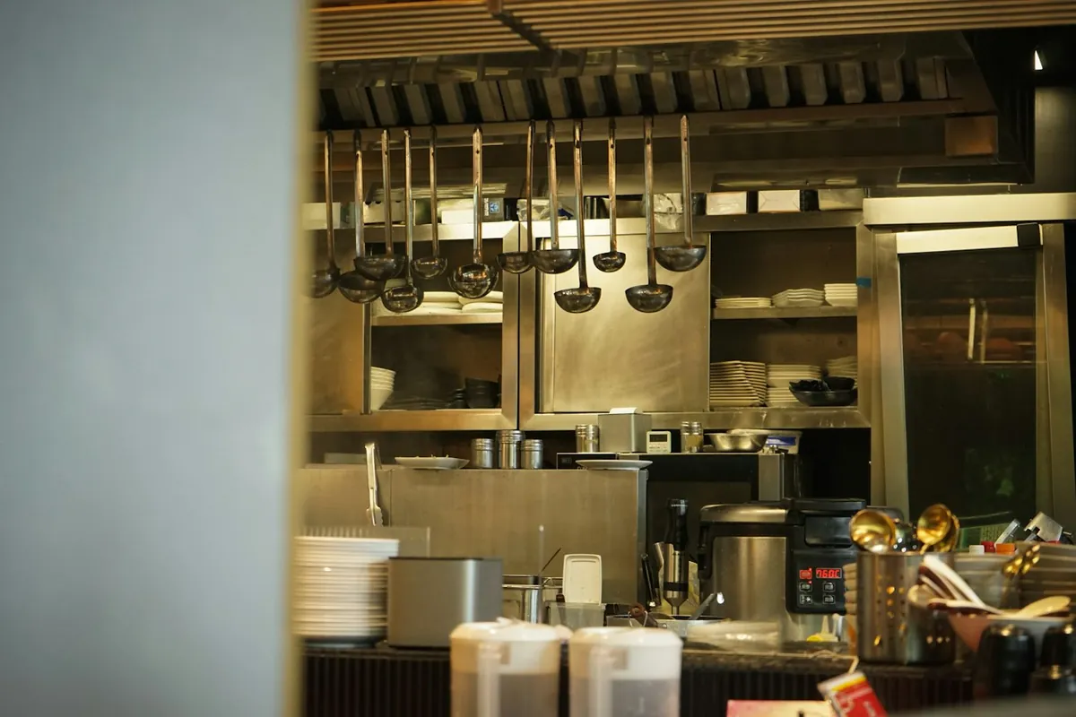 Commercial kitchen with stainless steel equipment and metal shelving