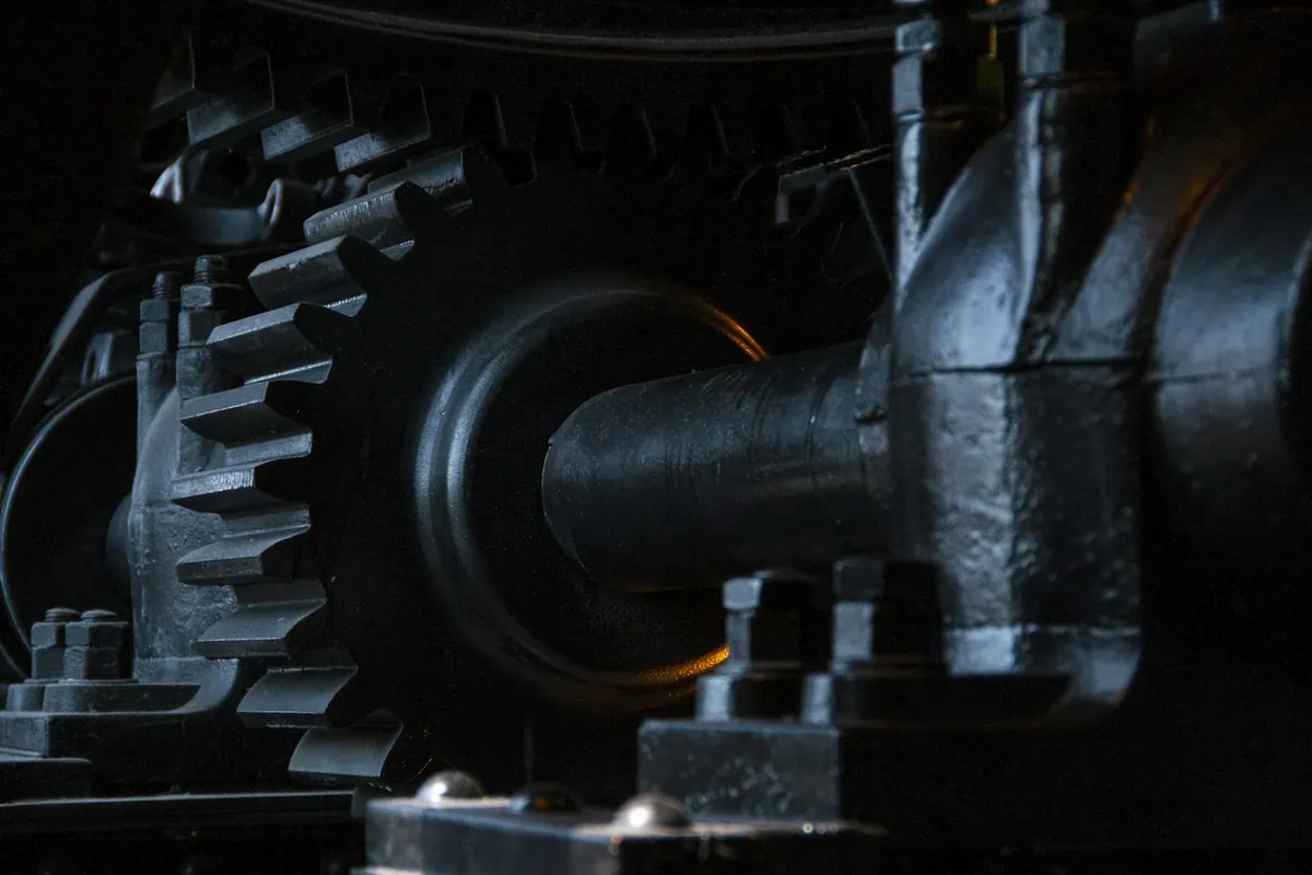 Close-up of dark metal gears and machinery in low light