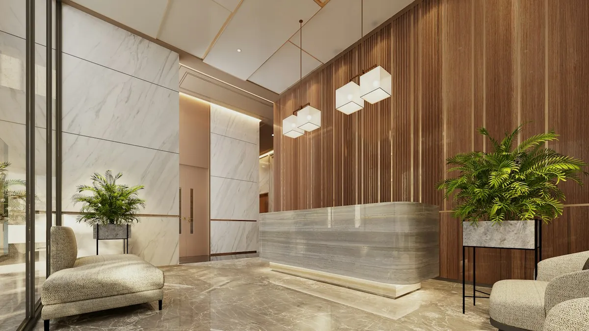 Modern building lobby with marble reception, wood panelling and plants