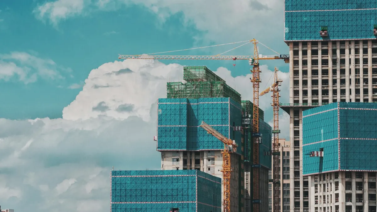 High-rise apartment towers under construction with tower cranes