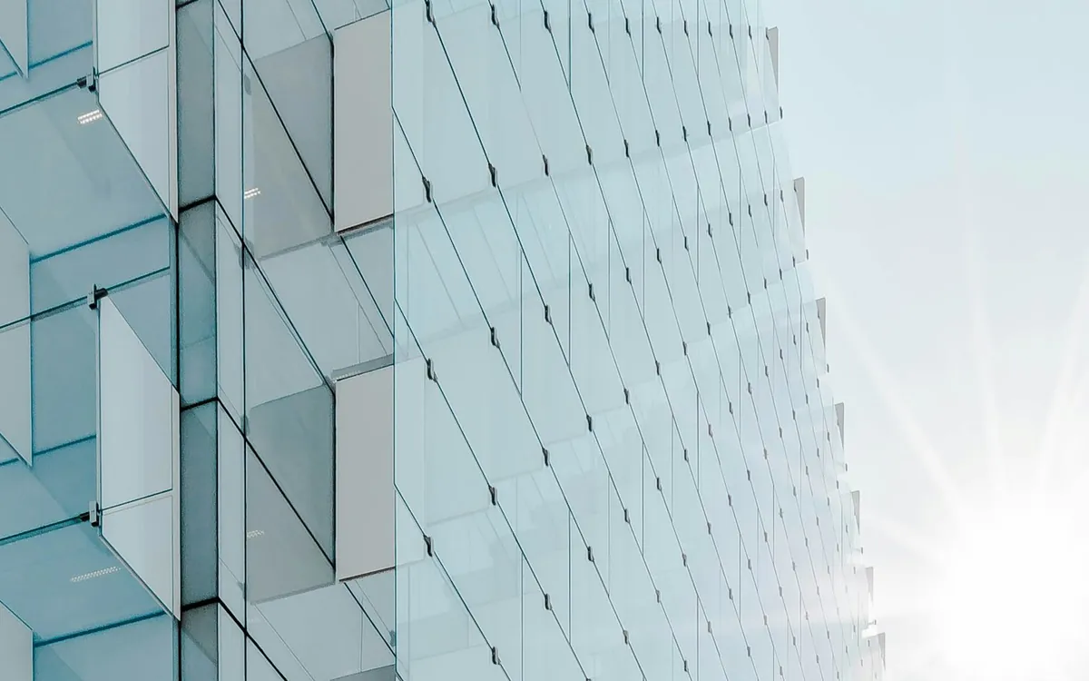 Glass facade of a modern building catching the sunlight