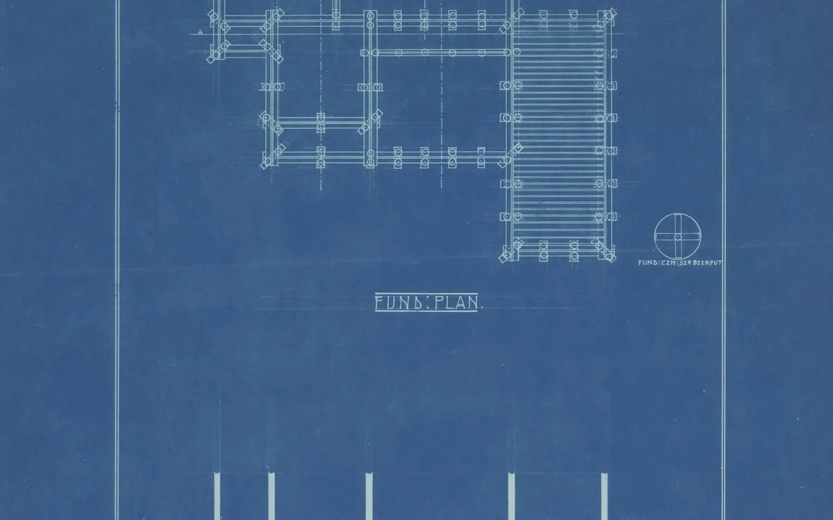 Architectural plan drawing with room layout on blue paper
