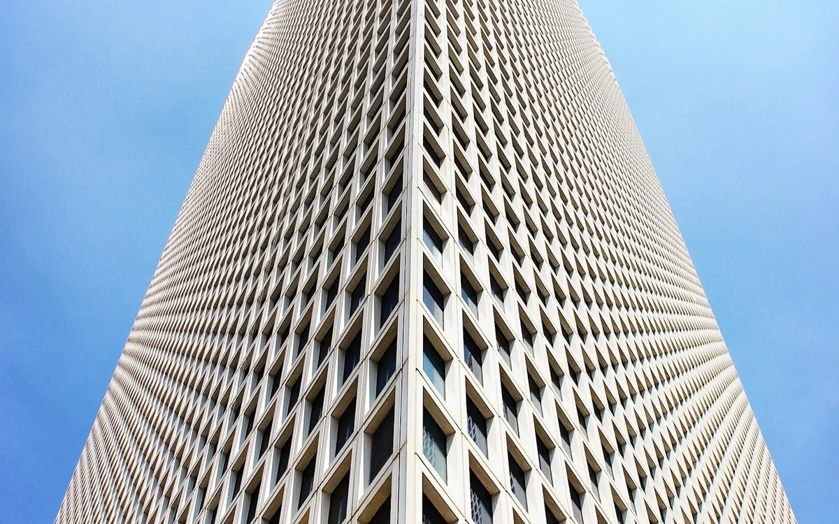 Tall building seen from below with a dense grid of windows