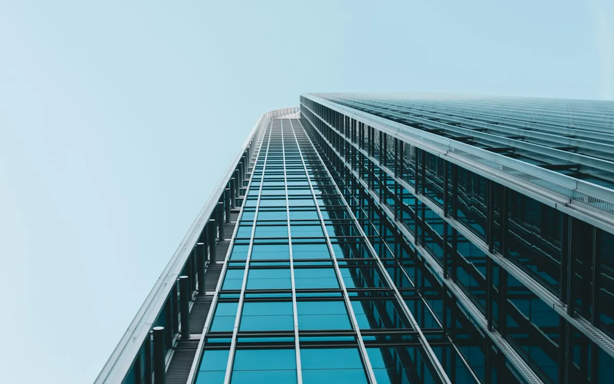 Glass tower facade seen from the base looking up