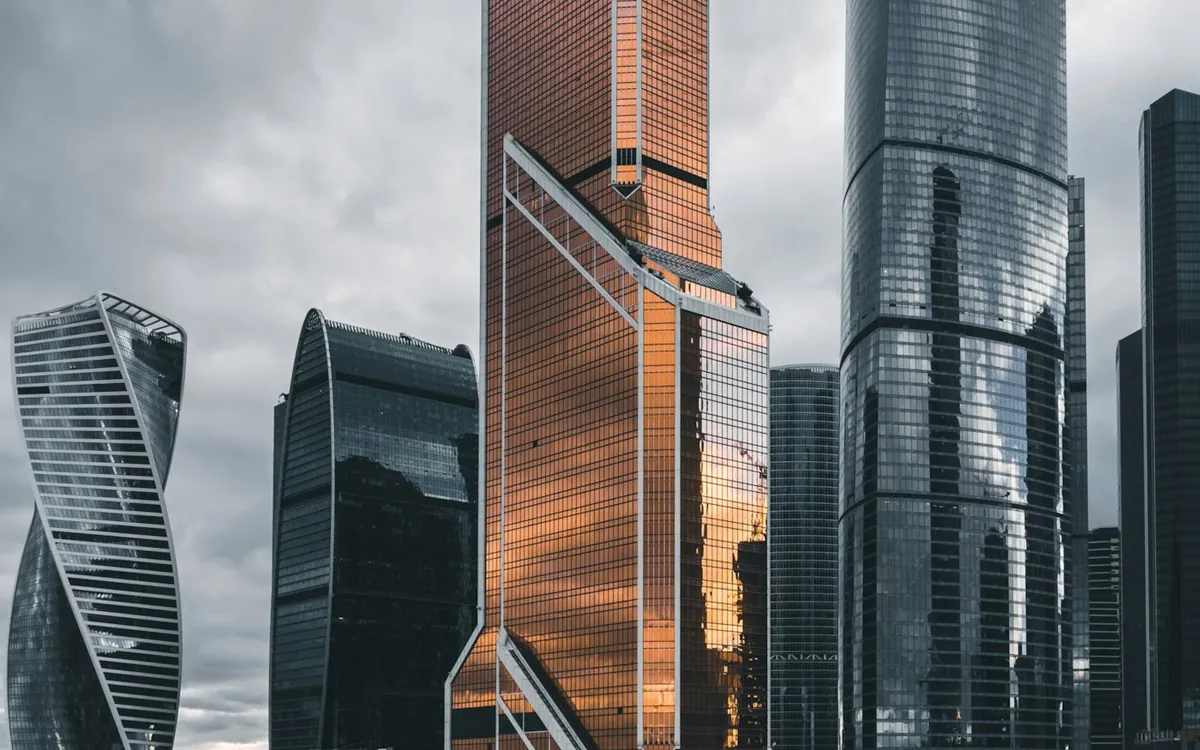 Skyscrapers of a large city cluster under a cloudy sky