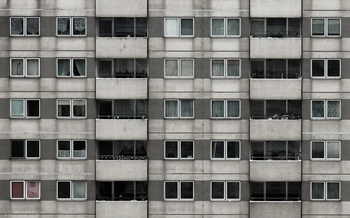 Apartment tower facade with a grid of balconies and windows