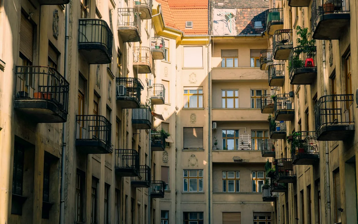 Apartment buildings with small balconies around a narrow urban courtyard