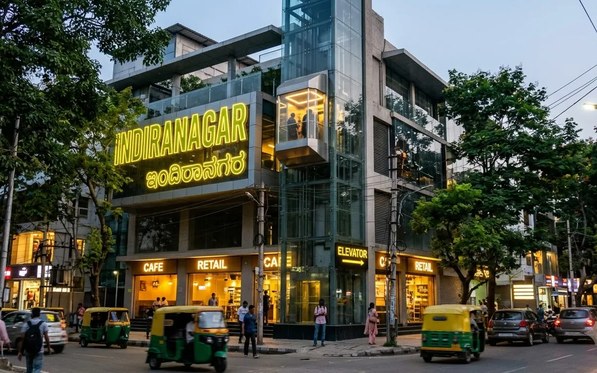 Elevator beside a boutique building on a busy Indiranagar street